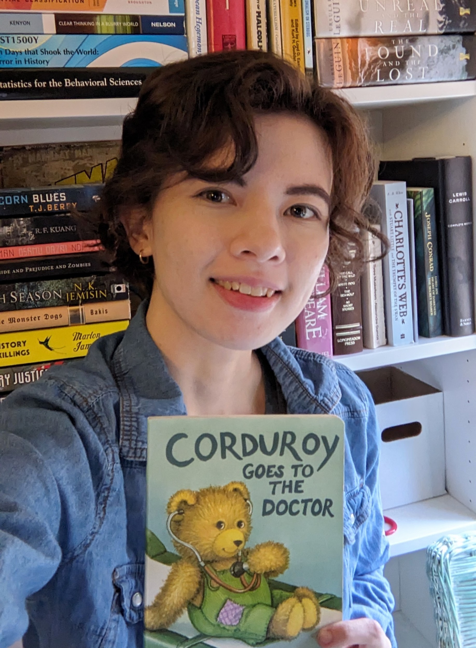 Isabel Shaw holding a children's book.
